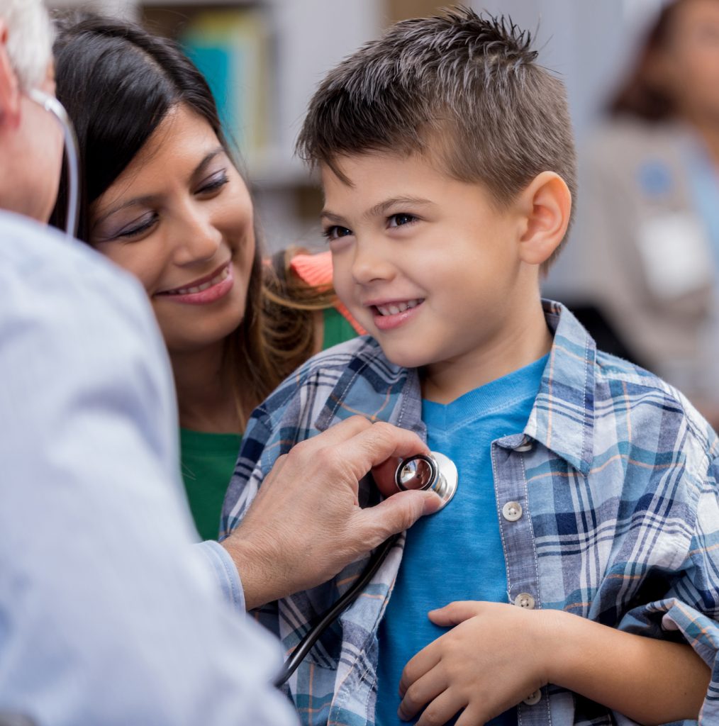 Pediatrician examines young male Hispanic patient