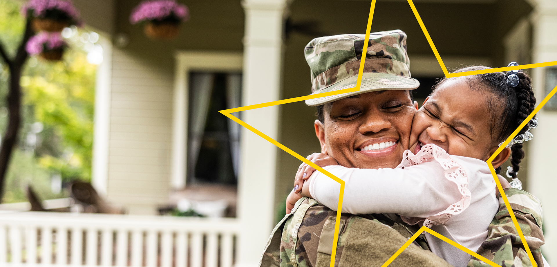 Mom in military uniform hugging young child